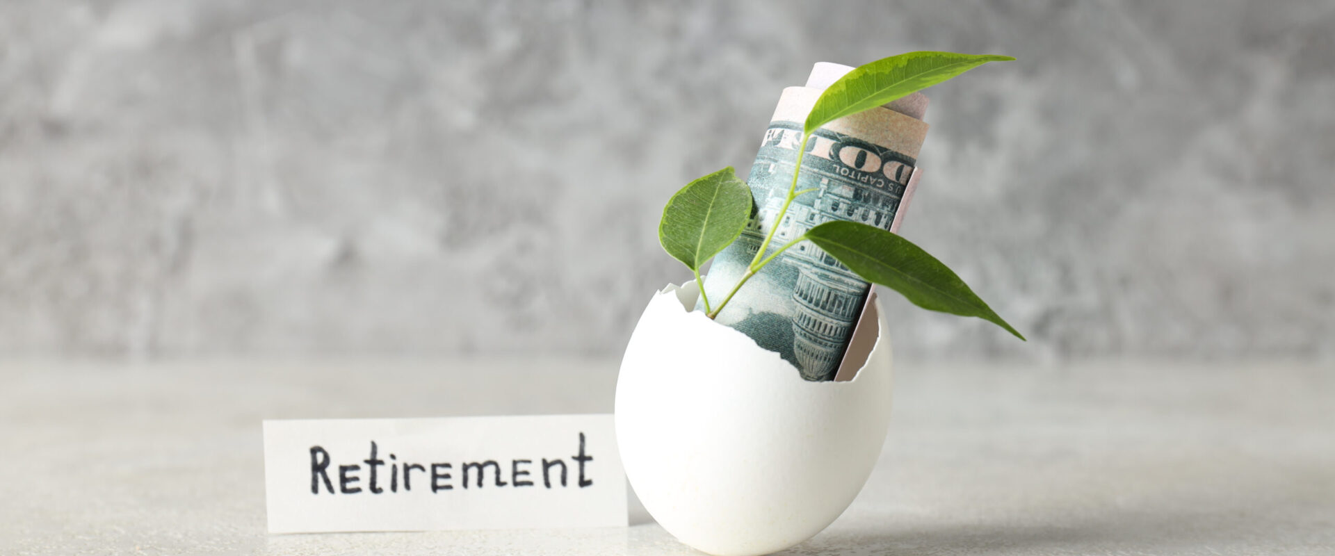 Composition with egg shell and money - retirement #image_title